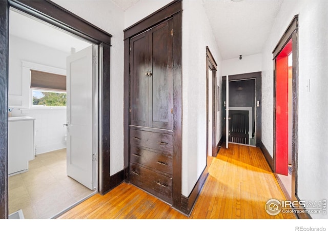 1805 8th St, Greeley, CO 80631 - hall featuring light wood finished floors and washer / dryer