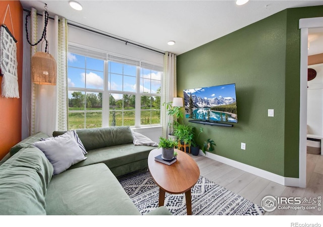 1922 Naturita St, Loveland, CO 80538 - living room with light wood-type flooring, baseboards, recessed lighting, and a textured wall