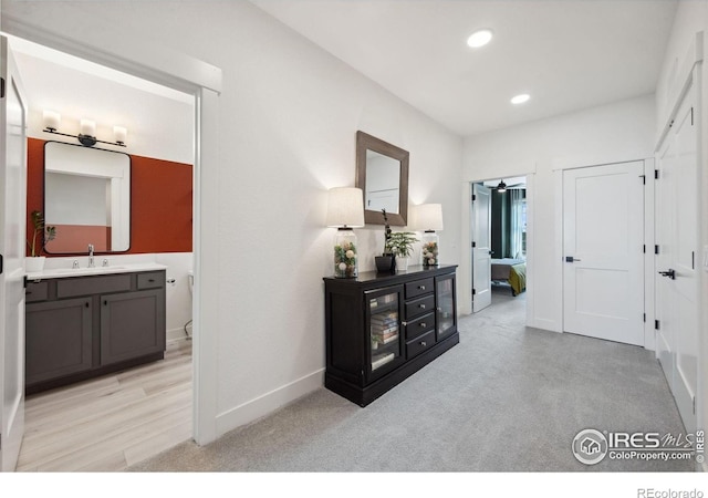 1922 Naturita St, Loveland, CO 80538 - corridor with a sink, light colored carpet, recessed lighting, and baseboards