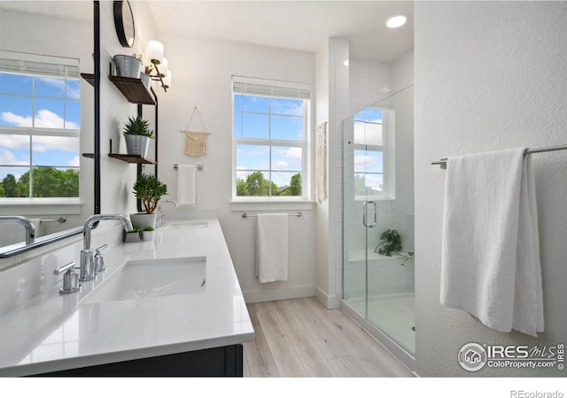 1922 Naturita St, Loveland, CO 80538 - full bath with wood finished floors, plenty of natural light, double vanity, and a shower stall