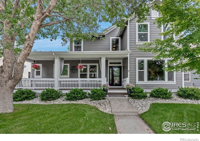 5111 Mt St Vrain Ave, Frederick, CO 80504 - view of front of property featuring a porch and a front lawn