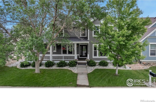 5111 Mt St Vrain Ave, Frederick, CO 80504 - view of property hidden behind natural elements featuring covered porch and a front lawn