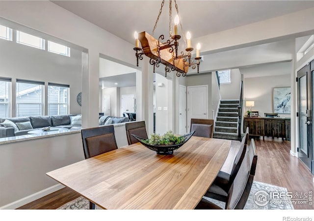 5111 Mt St Vrain Ave, Frederick, CO 80504 - dining room featuring stairs, a chandelier, and healthy amount of natural light