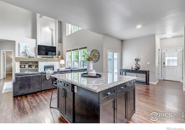 5111 Mt St Vrain Ave, Frederick, CO 80504 - kitchen with dark wood-style floors, healthy amount of natural light, a center island, and a towering ceiling