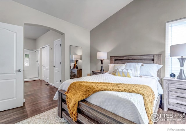 5111 Mt St Vrain Ave, Frederick, CO 80504 - bedroom with arched walkways, wood finished floors, and vaulted ceiling