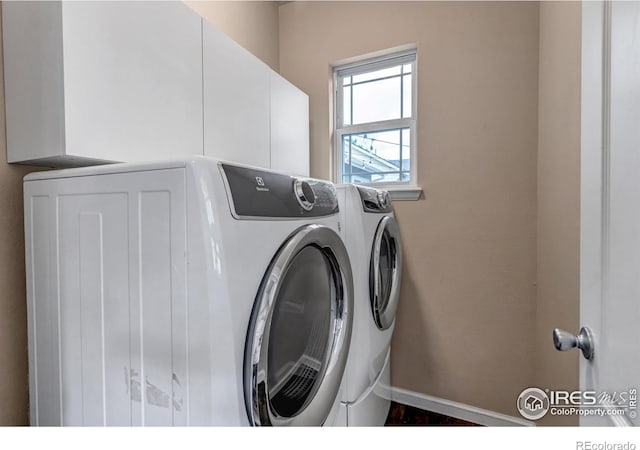 5111 Mt St Vrain Ave, Frederick, CO 80504 - laundry room with washer and clothes dryer, cabinet space, and baseboards