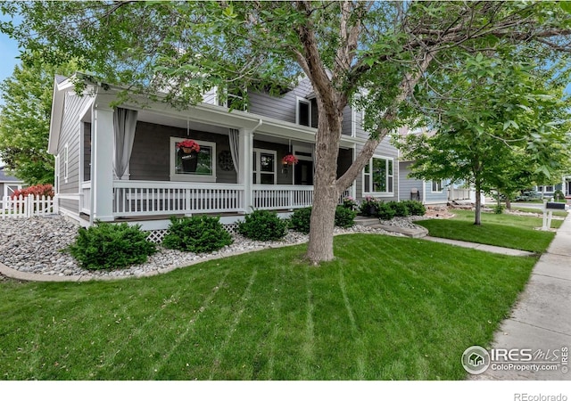 5111 Mt St Vrain Ave, Frederick, CO 80504 - view of property hidden behind natural elements featuring a porch and a front lawn