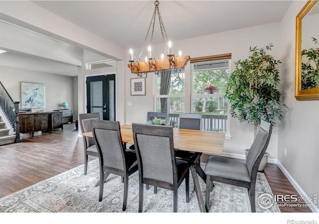 5111 Mt St Vrain Ave, Frederick, CO 80504 - dining room featuring a chandelier, wood finished floors, stairway, and baseboards