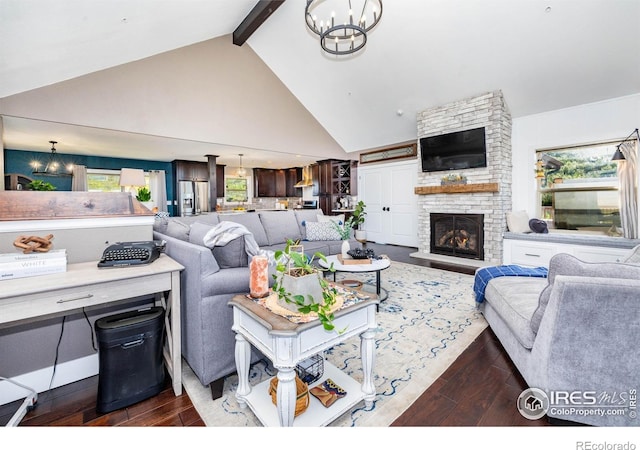 4721 Arthur Mae Ln, Laporte, CO 80535 - living area featuring dark wood-type flooring, a chandelier, high vaulted ceiling, beamed ceiling, and a large fireplace