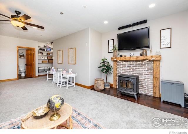 4721 Arthur Mae Ln, Laporte, CO 80535 - carpeted living area with a ceiling fan, baseboards, a wood stove, recessed lighting, and wood finished floors