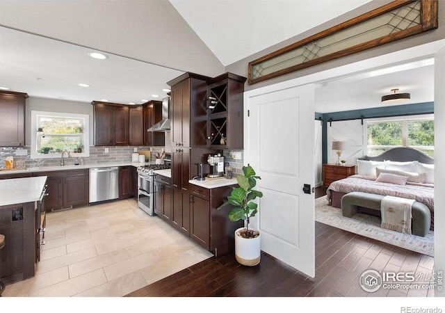 4721 Arthur Mae Ln, Laporte, CO 80535 - kitchen featuring appliances with stainless steel finishes, dark brown cabinets, light countertops, plenty of natural light, and lofted ceiling