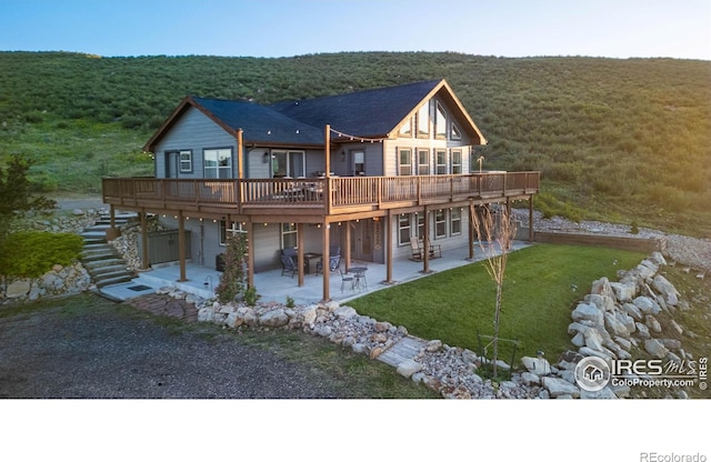 4721 Arthur Mae Ln, Laporte, CO 80535 - rear view of house with stairs, a patio, a wooden deck, and a view of trees