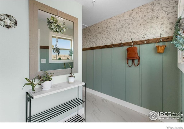 4721 Arthur Mae Ln, Laporte, CO 80535 - bathroom featuring marble look tile flooring, wallpapered walls, vanity, and wainscoting
