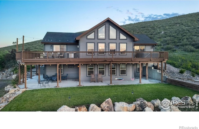 4721 Arthur Mae Ln, Laporte, CO 80535 - rear view of house with a patio area, a wooden deck, a lawn, and a wooded view