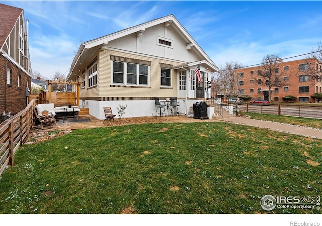 701 Mathews St, Fort Collins, CO 80524 - rear view of house featuring brick siding, a patio, and outdoor lounge area