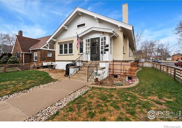 701 Mathews St, Fort Collins, CO 80524 - view of front of house featuring brick siding and a chimney