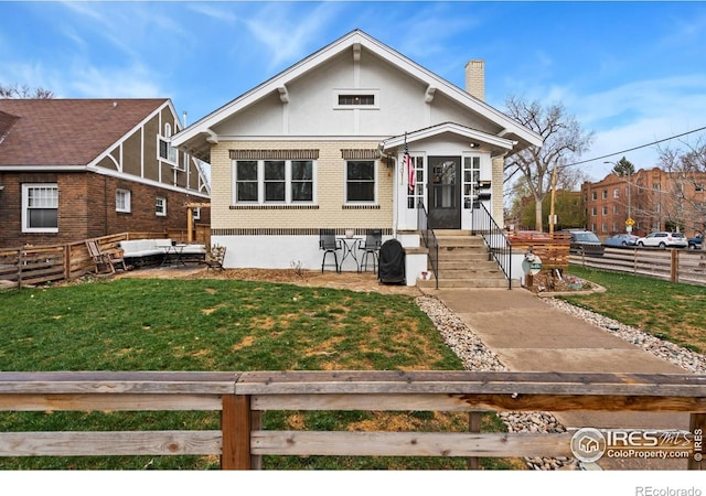 701 Mathews St, Fort Collins, CO 80524 - view of front of property with an outdoor living space, a chimney, and brick siding