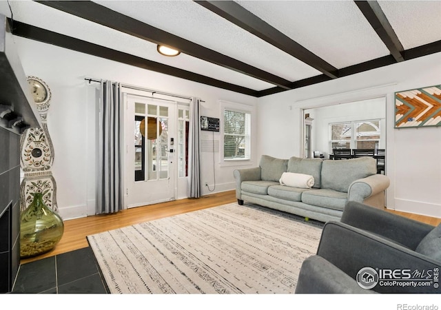 701 Mathews St, Fort Collins, CO 80524 - living room with beam ceiling, baseboards, and wood finished floors
