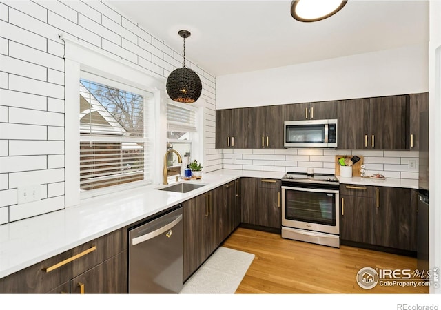 701 Mathews St, Fort Collins, CO 80524 - kitchen featuring appliances with stainless steel finishes, a sink, decorative backsplash, and dark brown cabinetry