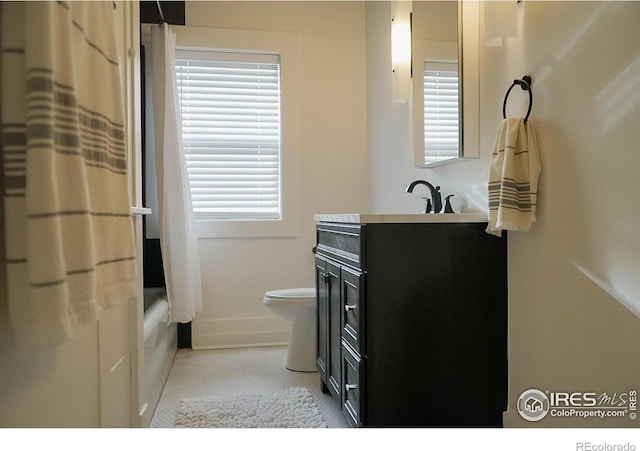701 Mathews St, Fort Collins, CO 80524 - full bath with toilet, vanity, shower / bath combination with curtain, baseboards, and tile patterned flooring