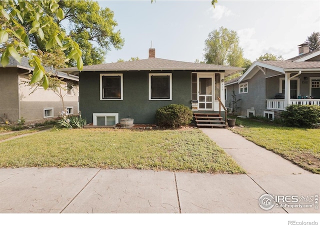 416 E Elizabeth St, Fort Collins, CO 80524 - bungalow-style house with a front lawn, a chimney, stucco siding, and roof with shingles