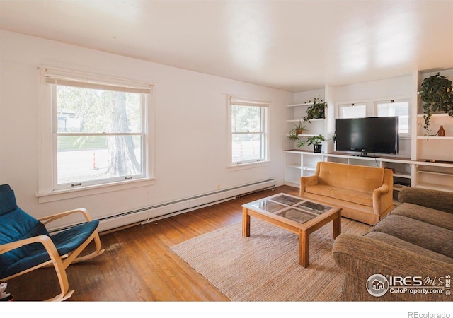 416 E Elizabeth St, Fort Collins, CO 80524 - living area with baseboard heating, plenty of natural light, and wood finished floors