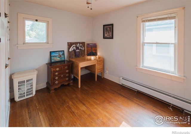 416 E Elizabeth St, Fort Collins, CO 80524 - home office featuring a baseboard radiator, wood finished floors, plenty of natural light, and baseboards