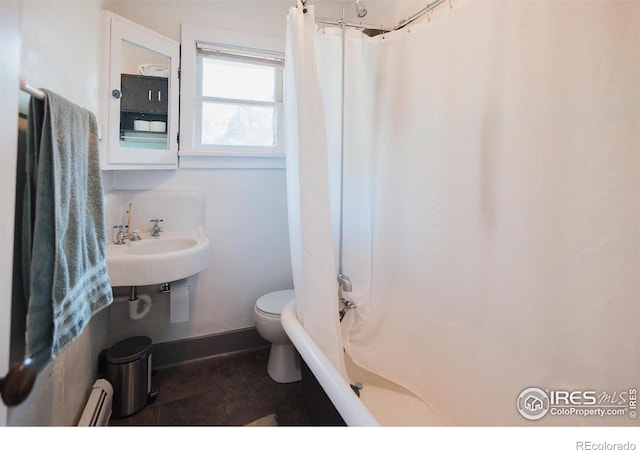 416 E Elizabeth St, Fort Collins, CO 80524 - full bathroom featuring toilet, a baseboard heating unit, a sink, baseboards, and shower / bath combo with shower curtain