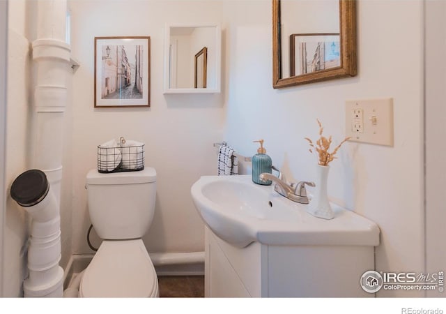 416 E Elizabeth St, Fort Collins, CO 80524 - half bathroom featuring toilet, vanity, and baseboards