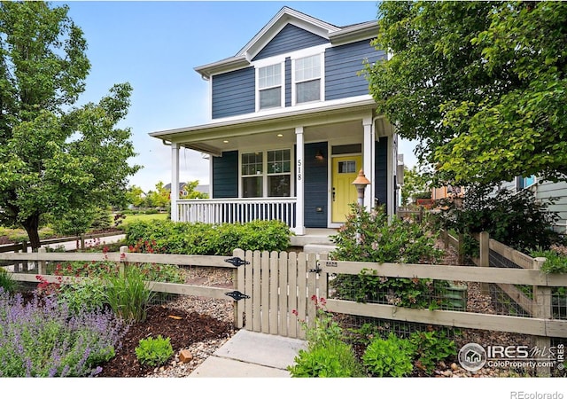 518 Hoyt Ln, Lafayette, CO 80026 - view of front of home featuring covered porch, a gate, and a fenced front yard