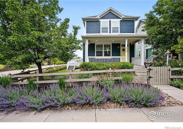 518 Hoyt Ln, Lafayette, CO 80026 - view of front of house featuring covered porch, a fenced front yard, and a gate