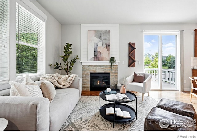 518 Hoyt Ln, Lafayette, CO 80026 - living room featuring a stone fireplace and wood finished floors