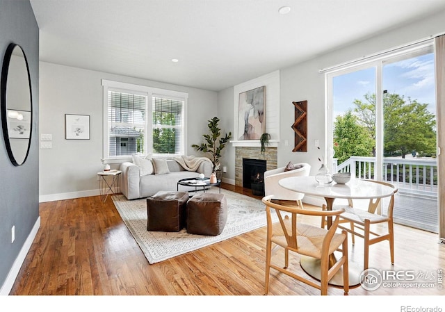 518 Hoyt Ln, Lafayette, CO 80026 - living area featuring wood finished floors, a stone fireplace, and baseboards
