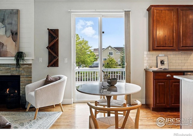 518 Hoyt Ln, Lafayette, CO 80026 - dining area featuring light wood-style flooring and a fireplace
