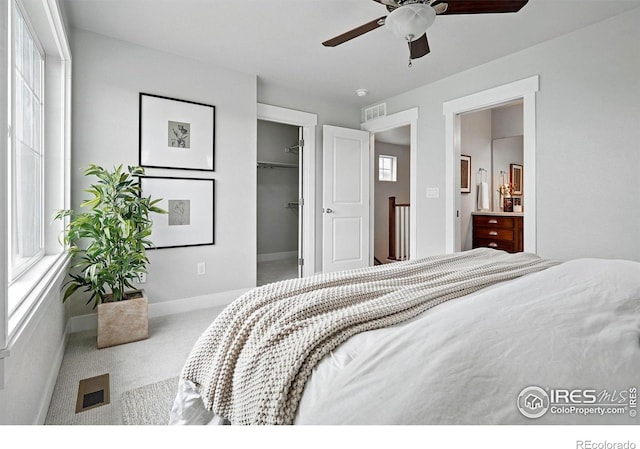 518 Hoyt Ln, Lafayette, CO 80026 - carpeted bedroom with multiple windows, a spacious closet, baseboards, and a ceiling fan