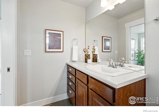 518 Hoyt Ln, Lafayette, CO 80026 - bathroom with vanity, baseboards, and wood finished floors