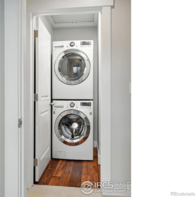 518 Hoyt Ln, Lafayette, CO 80026 - laundry room with stacked washing machine and dryer and dark wood-style flooring