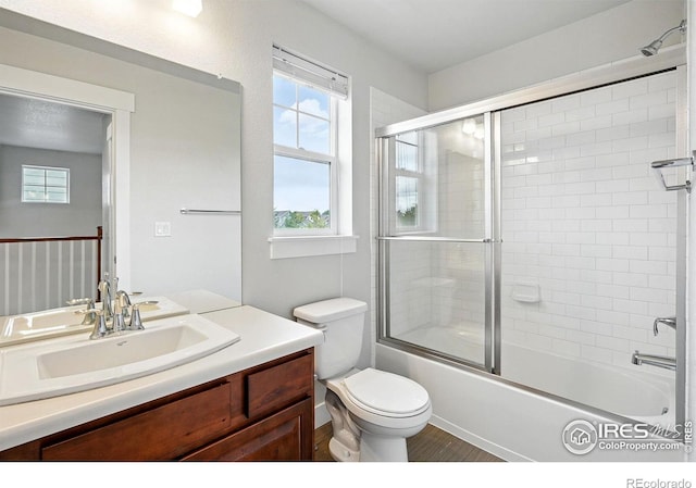 518 Hoyt Ln, Lafayette, CO 80026 - bathroom featuring vanity, toilet, bath / shower combo with glass door, and healthy amount of natural light