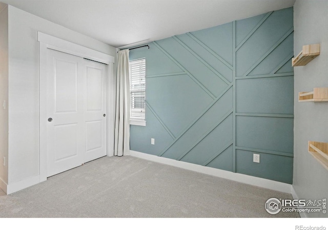 518 Hoyt Ln, Lafayette, CO 80026 - unfurnished bedroom with carpet floors, baseboards, a closet, and a decorative wall