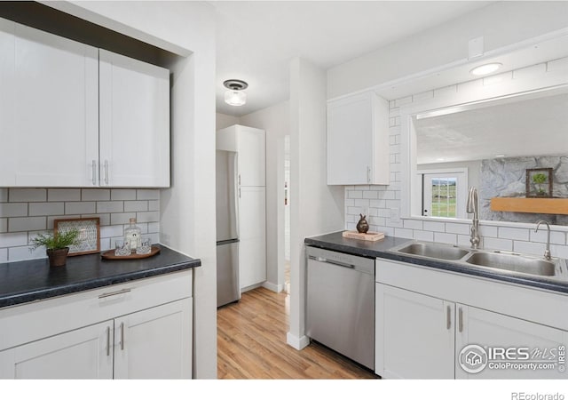 2836 W County Road 60e, Fort Collins, CO 80524 - kitchen with stainless steel appliances, a sink, decorative backsplash, and white cabinets