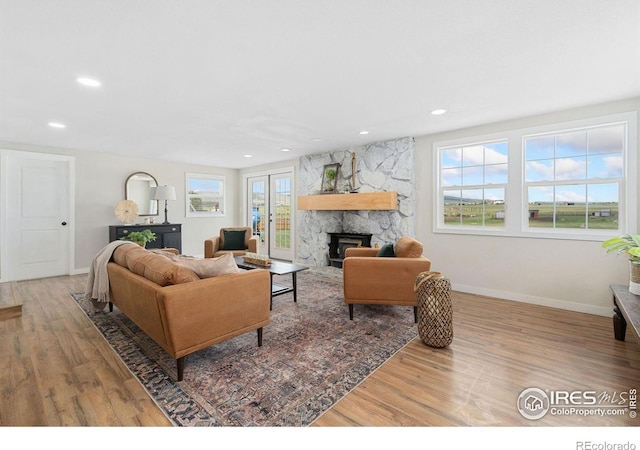 2836 W County Road 60e, Fort Collins, CO 80524 - living area featuring a stone fireplace, wood finished floors, baseboards, and recessed lighting