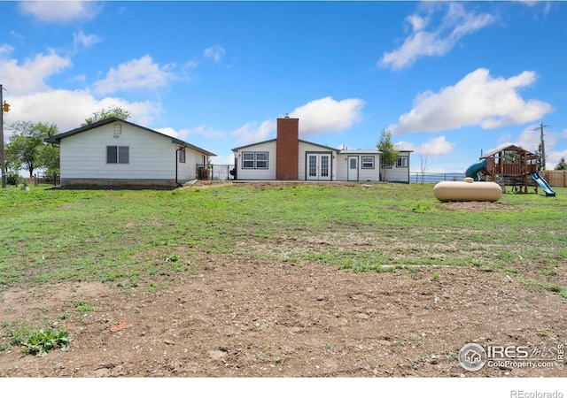 2836 W County Road 60e, Fort Collins, CO 80524 - rear view of property featuring a playground, french doors, and a chimney