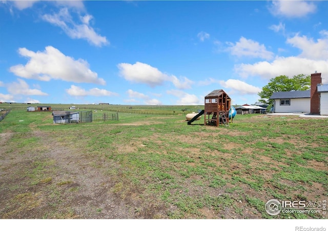 2836 W County Road 60e, Fort Collins, CO 80524 - view of green lawn featuring a playground and a rural view