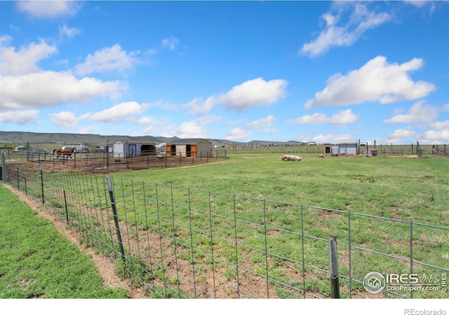 2836 W County Road 60e, Fort Collins, CO 80524 - view of green lawn with a rural view, an outdoor structure, and an exterior structure