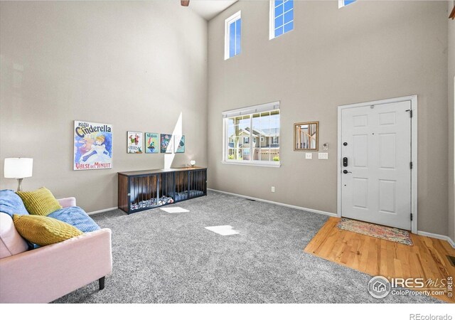 13445 Kearney St, Thornton, CO 80602 - carpeted living room featuring a towering ceiling and baseboards