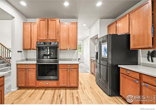 13445 Kearney St, Thornton, CO 80602 - kitchen with multiple ovens, light wood-style floors, light countertops, and recessed lighting