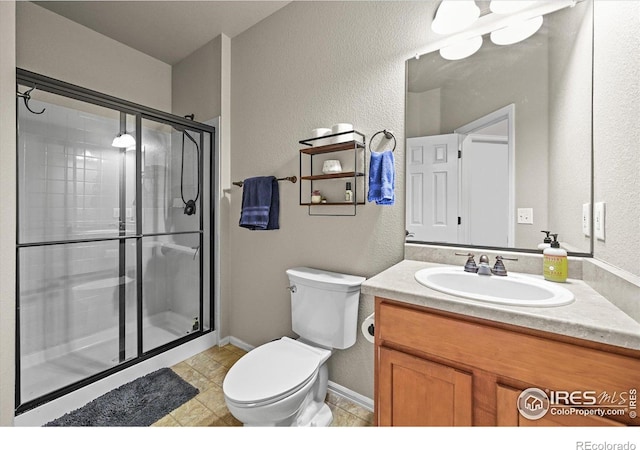 13445 Kearney St, Thornton, CO 80602 - full bath featuring toilet, a shower stall, vanity, and a textured wall