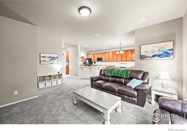 13445 Kearney St, Thornton, CO 80602 - living area with carpet, baseboards, and recessed lighting