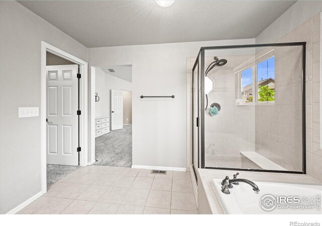 13445 Kearney St, Thornton, CO 80602 - bathroom featuring a bath, a shower stall, baseboards, and tile patterned flooring