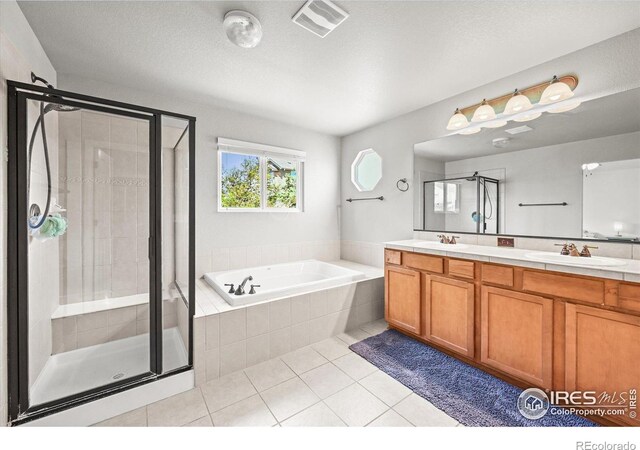 13445 Kearney St, Thornton, CO 80602 - full bath featuring a garden tub, double vanity, a stall shower, and tile patterned floors